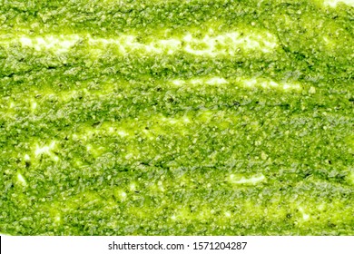 Pesto Spread Pattern, Texture On White Background. Green Italian Homemade Spilled Sauce Made Of Ground Basil, Garlic, Pine Seeds, Olives And Pecorino Sardo Cheese Top View