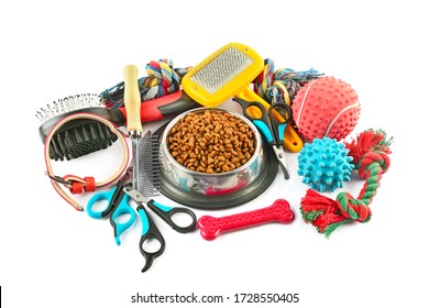 Pet accessories concept. Dry food, collars and rubber toys for pet on isolated white background.