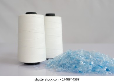 PET bottle flake or Plastic bottle crushed & Raw White Polyester FDY Yarn spool with white background