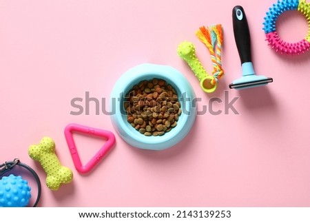 Pet care, training, grooming concept. Pet toys, accessories, bowl of feed on pink background. Top view, flat lay.