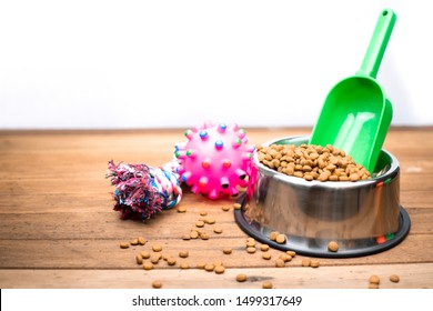 Pet food with accessories on wooden table.  Dry food for dog or cat