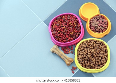 Pet Food In  Bowls On A Floor.