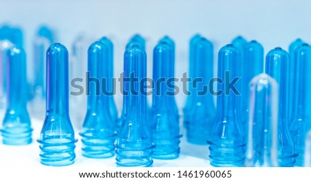 PET plastic bottle preforms before blow molding. Packaging industry. PET preforms from preforms injection molding machine. Raw material for PET bottle. Recycle plastic. Polyethylene terephthalate.