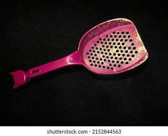 Pet Sand Shovel Isolated On A Black Background