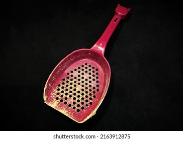 Pet Sand Shovel Isolated On A Black Background