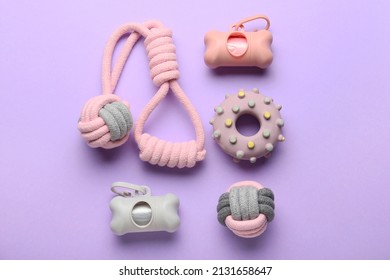 Pet Waste Bags And Toys On Lilac Background