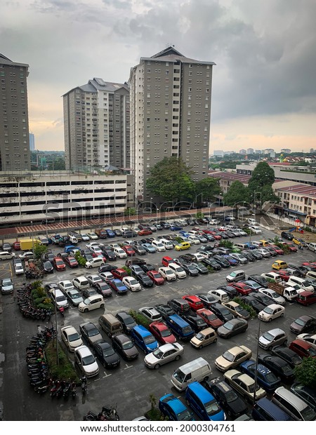 Petaling Jaya, Malaysia\
1st July 2021 - Hundreds of cars and motorcycles in the parking lot\
of an apartment.