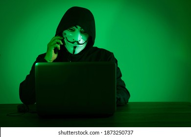 Petaling Jaya,Malaysia, December 11th, 2020: Man with the laptop wearing Vendetta mask - symbol for the online hacktivist group Anonymous
