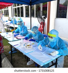 Petaling, Malaysia. May 12, 2020. Health Care Frontliners Workers In Ppe Registering People Outdoor To Be Tested For Covid-19 During Pandemic. 