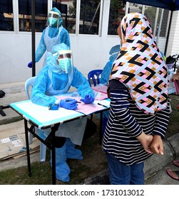 Petaling, Malaysia. May 12, 2020. Health Workers Frontliners In PPE Registering People Outdoor To Be Tested On Covid-19 Virus Infection During Pandemic. 