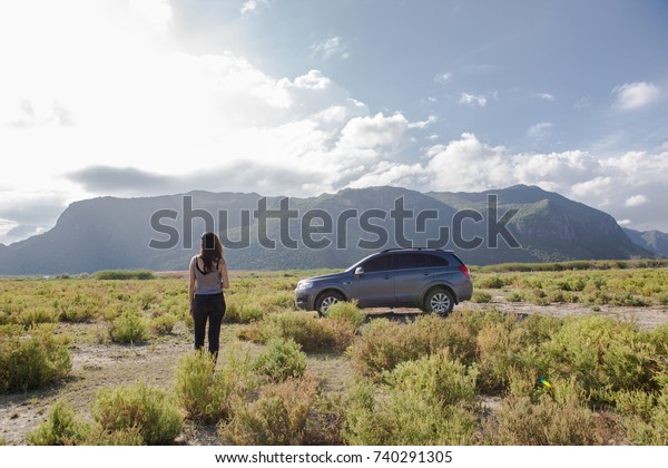 Petchburi ,Thailand -August\
30 2017: Private car test drive, Gray color Chevrolet Captiva Photo\
with women on country road in sunset time at 300 Yod\
Mountain,Thailand