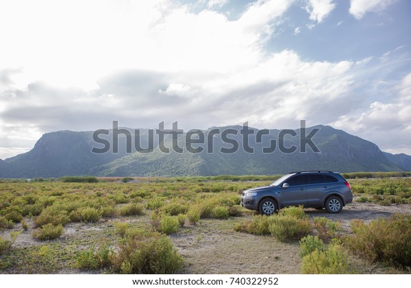 Petchburi ,Thailand -August
30 2017: Private car test drive, Gray color Chevrolet Captiva Photo
with women on country road in sunset time at 300 Yod
Mountain,Thailand