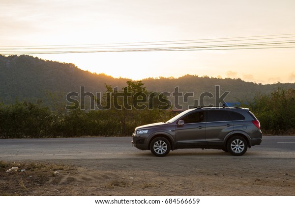 Petchburi ,Thailand -May 8 2014:\
Private car test drive, Gray color Chevrolet Captiva Photo on\
country road at\
Petchburi,Thailand
