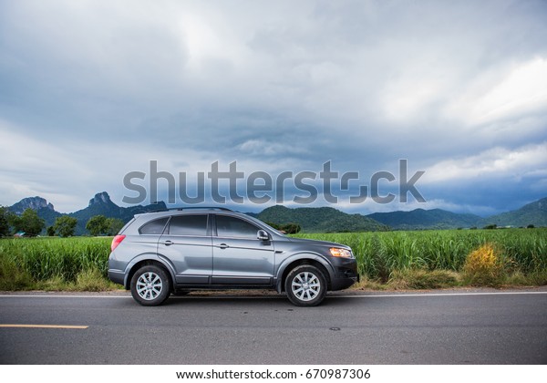 Petchburi,Thailand -June 30 2017:
Private car test drive, Gray color Chevrolet Captiva Photo on
country road  at
Petchburi,Thailand