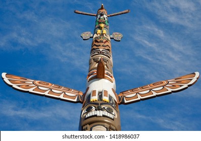 Peterborough, Ontario, Canada - May 27, 2019: Beautiful And Colourful Totem Pole In Blue Skies Crafted By Local Artist Jody Paudash Of Hiawatha First Nation Inside The Riverview Park And Zoo.