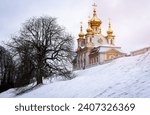 Peterhof palace, The gilded domes of the court church of the Holy Apostles Peter and Paul, built by order of Empress Elizabeth Petrovna in 1751, snow on the ground.
