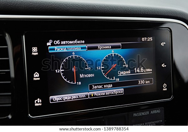 Petersburg, Russia -\
July 2017:   Modern media display in the interior of the car. Touch\
screen with multimedia shows the graph of fuel consumption in\
Mitsubishi\
Outlander