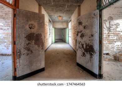 Petersburg, VA / USA - 051720 : Hallway With Colorful Doors In The Isolation Ward Of An Abandoned Hospital