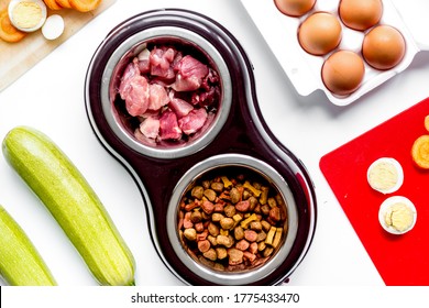 petfood set with vegetables and eggs on kitchen table background top view