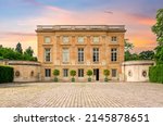 Petit Trianon in Versailles park outside Paris at sunset, France