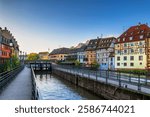 Petite France district in city of Strasbourg in Alsace, France. Picturesque historic quarter with flood gate and Alsatian style buildings at canal of River Ill.