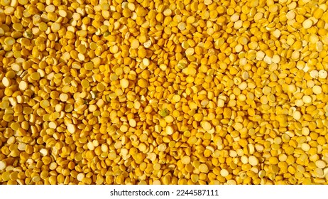 Petite yellow lentils background texture, pattern. Pile of lentil pulse beans. Beautiful split chickpeas. Collection of Raw lentils, Chana dal, split peas. Uncooked dry toor dal grains, seeds, kernels - Shutterstock ID 2244587111