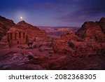 Petra historical sight - Ad Deir Monastery with full moon during the night. Evening light in nature. Travel in Jordan, Arabia in Asia. Stone Monastery in rock, Petra in Jordan. Red rock landcape.