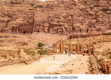 Petra main street with ancient Nabataean Royal tombs in the background and ruins of grand temple in the foreground, Petra, Jordan