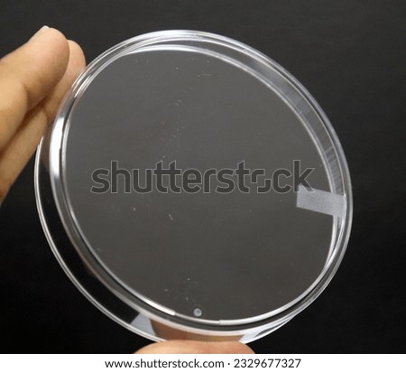 A Petri dish (alternatively known as a Petri plate or cell-culture dish) is a shallow transparent lidded dish that biologists use to hold growth medium in which microorganisms can be cultured.