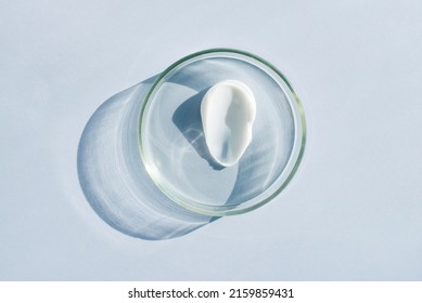 petri dish with cream smear sample on light background