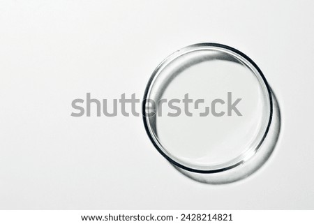 Petri dish with liquid, oil, gel, water, molecules, viruses. On a white background.