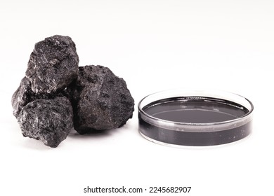 petri dish with petroleum, fuel oil, isolated white background, with stone petroleum coke ore, petroleum products and refined products, industrial use - Shutterstock ID 2245682907