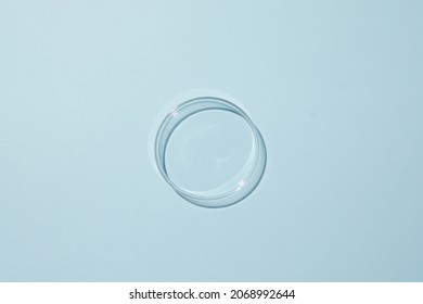 Petri Dish With Water And Different Ripple On Blue Background