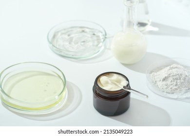 Petri Dishes With Medium And Glassware On A Laboratory Table. Fermentation, Fermented Beauty Skin Care. Container With Cream Or Solution Or Serum For Anti Age Treatment Developed In A Lab.