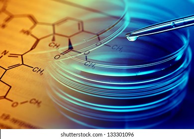 Petri dishes, pipette and chemical formula. Laboratory concept.