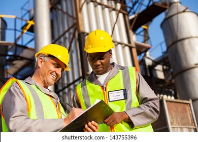 petrochemical co-workers working at refinery plant - Powered by Shutterstock