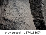 Petroglyph stone etching on a granite boulder in the Enchanted Valley in Chile