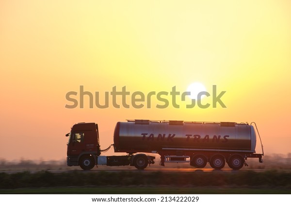 Petrol cargo truck driving on highway hauling oil\
products. Delivery transportation and logistics concept. Kyiv,\
Ukraine - October 12,\
2021.