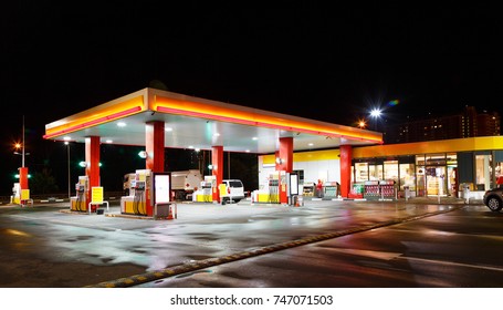 Petrol gas station station at night with lights on and mini-mart  - Shutterstock ID 747071503