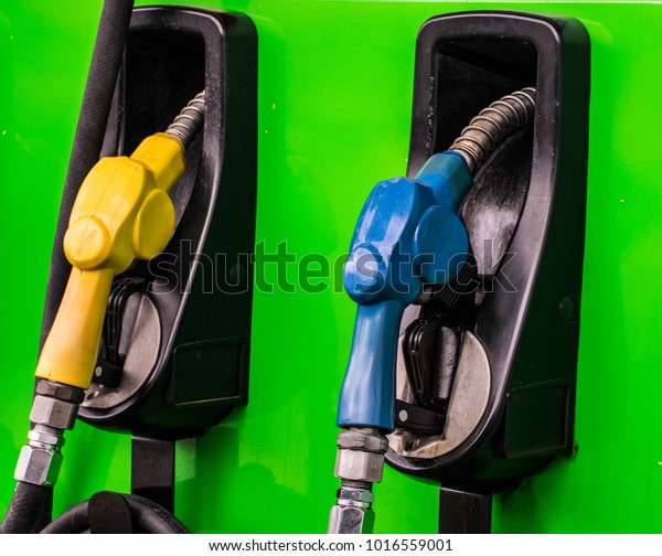 Petrol pump filling\
nozzles in gas station