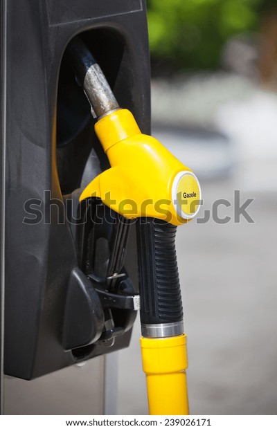Petrol
pump nozzle in a service station. Vertical
shot