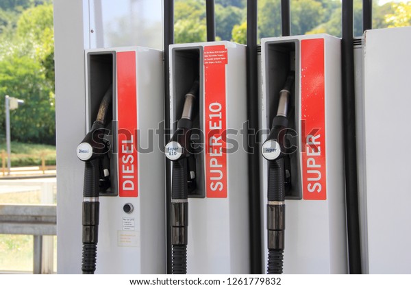 petrol pumps at a gas station with the text
