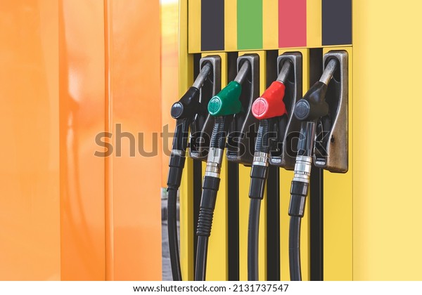Petrol station with\
colored guns and fuel hoses. Gasoline, diesel, eco hydrogen\
refueling column..\
Close-up