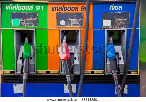Petroleum station Chonburi, Thailand : July 5, 2017 :\
Different types of full dispensers using the color of the depending\
head and type of oil.\
