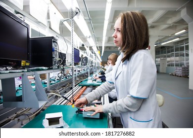 Petropavl, Kazakhstan - May 11 2012: Modern electronic-production plant. Young attractive woman on device 
assembling line. - Shutterstock ID 1817276882