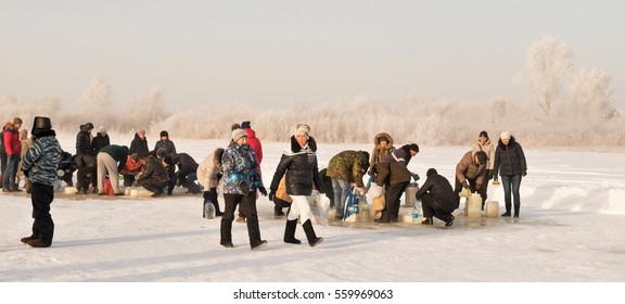 PETROPAVLOVSK, KAZAKHSTAN- JANUARY 19, 2017: The Baptism of Russia celebration. Orthodox church Holy Epiphany Day. People take water from the river. Weather -22, winter. - Shutterstock ID 559969063
