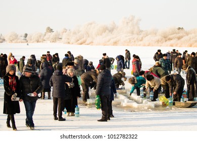PETROPAVLOVSK, KAZAKHSTAN- JANUARY 19, 2018: The Baptism. People swim in the ice hole in winter. - Shutterstock ID 1012782322