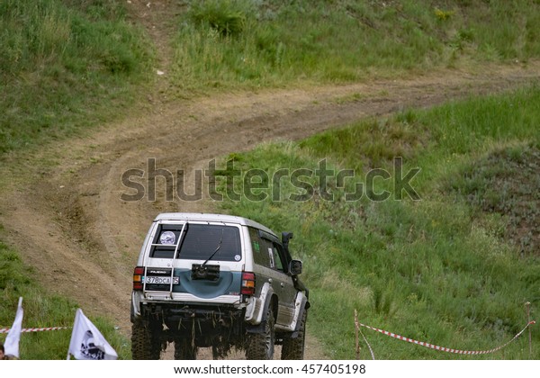 Petropavlovsk, Kazakhstan - JULY 24, 2016:\
off-road vehicle cars moving on the off road at competitions,\
Petropavlovsk, Kazakhstan. Joyful\
viewers.