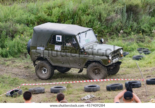 Petropavlovsk, Kazakhstan - JULY 24, 2016:\
off-road vehicle cars moving on the off road at competitions,\
Petropavlovsk, Kazakhstan. Joyful\
viewers.