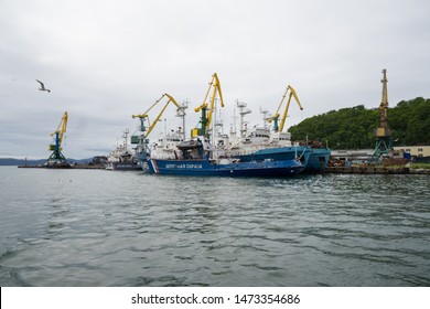 Petropavlovsk-Kamchatsky, Kamchatka / Russia - July 29 2019: Seascape Of The Capital From The Harbor. Translation From Russian: Coastal Guard. Guarding Boats Mooring At The Pier Ready To React Quickly